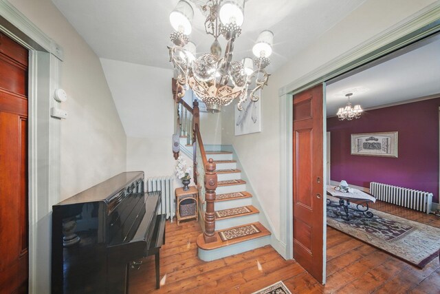 482 Scotchtown Ave, Middletown, NY 10941 - stairway with a chandelier, radiator heating unit, and hardwood / wood-style floors