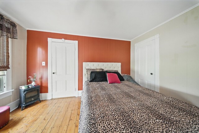 482 Scotchtown Ave, Middletown, NY 10941 - bedroom with light wood-type flooring, crown molding, and a wood stove