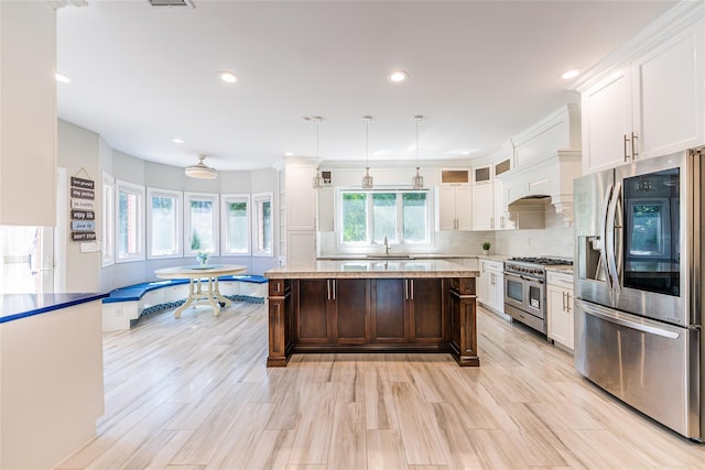 151 Birch Dr, Manhasset Hills, NY 11040 - kitchen with appliances with stainless steel finishes, white cabinetry, backsplash, pendant lighting, and recessed lighting