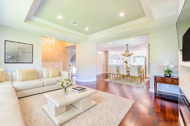 151 Birch Dr, Manhasset Hills, NY 11040 - living area with a chandelier, a tray ceiling, dark wood-type flooring, and recessed lighting