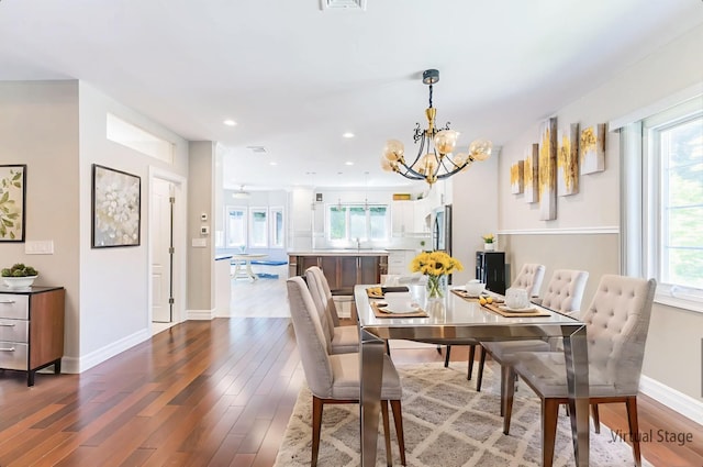 151 Birch Dr, Manhasset Hills, NY 11040 - dining area featuring wood finished floors, healthy amount of natural light, a chandelier, and recessed lighting