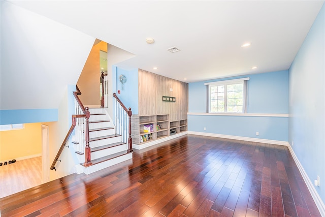 151 Birch Dr, Manhasset Hills, NY 11040 - unfurnished living room featuring wood-type flooring and stairway
