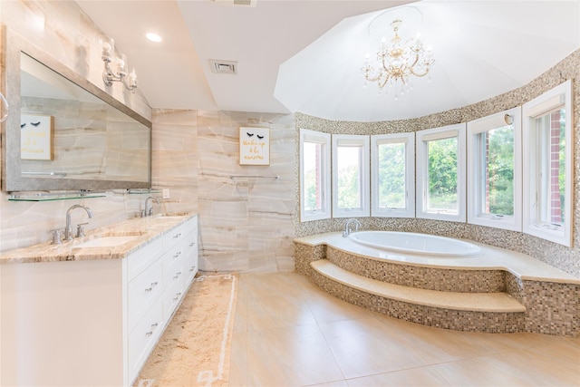 151 Birch Dr, Manhasset Hills, NY 11040 - bathroom with double vanity, tile patterned floors, a garden tub, tile walls, and a chandelier