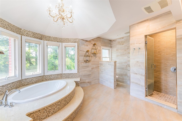 151 Birch Dr, Manhasset Hills, NY 11040 - bathroom featuring a bath, a shower stall, a chandelier, tile walls, and tile patterned flooring