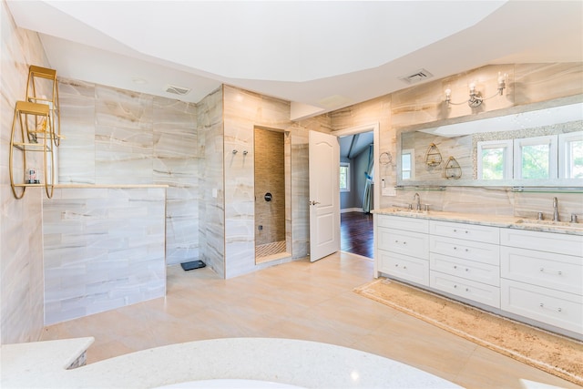 151 Birch Dr, Manhasset Hills, NY 11040 - bathroom featuring walk in shower, double vanity, healthy amount of natural light, and tile walls