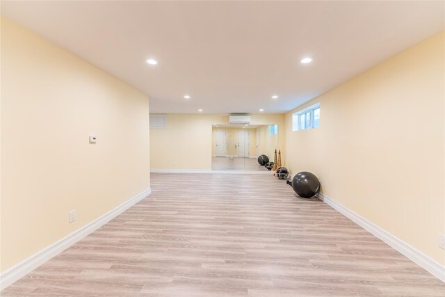 151 Birch Dr, Manhasset Hills, NY 11040 - workout room with recessed lighting, a wall mounted air conditioner, and light wood finished floors