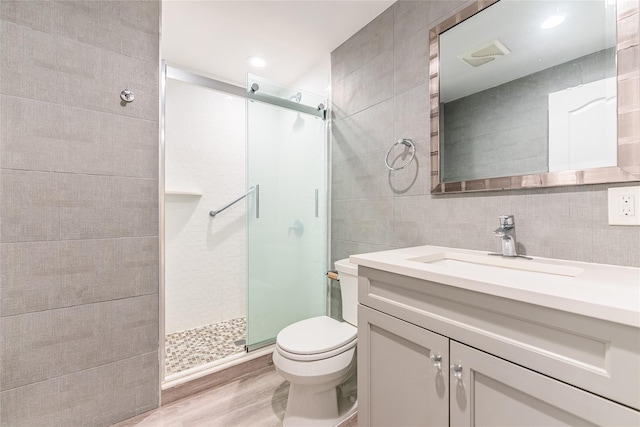 151 Birch Dr, Manhasset Hills, NY 11040 - bathroom with tile walls, a shower stall, vanity, and wood finished floors