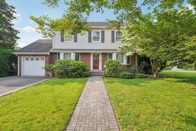 54 Ogden Ave, East Williston, NY 11596 - traditional-style home with an attached garage, brick siding, asphalt driveway, and a front yard