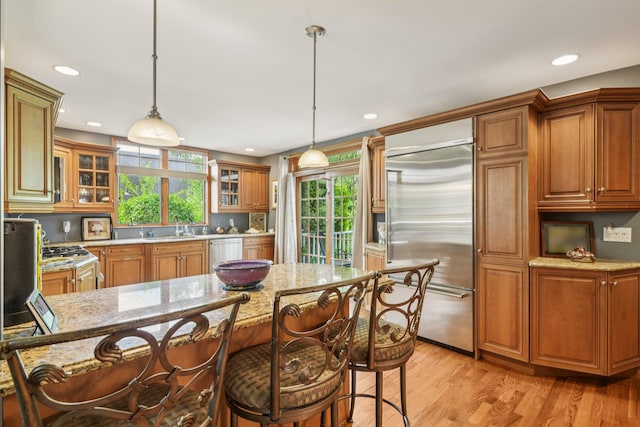 54 Ogden Ave, East Williston, NY 11596 - kitchen with appliances with stainless steel finishes, brown cabinetry, plenty of natural light, and recessed lighting