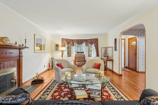 54 Ogden Ave, East Williston, NY 11596 - living area featuring arched walkways, a fireplace, wood finished floors, ornamental molding, and baseboards