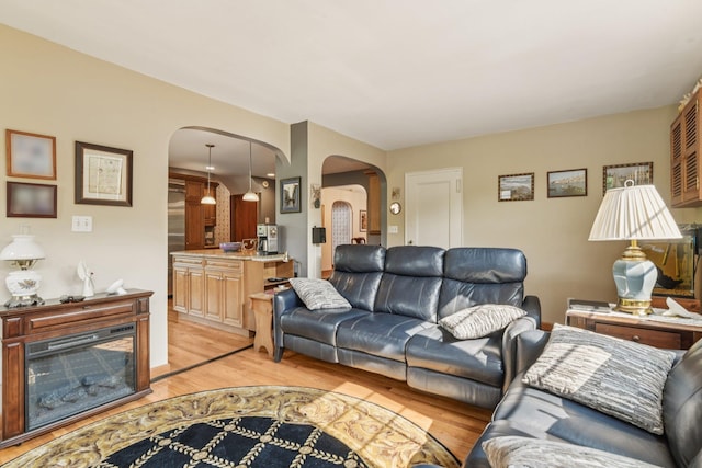 54 Ogden Ave, East Williston, NY 11596 - living room featuring arched walkways and light wood-style floors