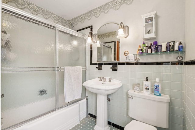 54 Ogden Ave, East Williston, NY 11596 - full bath with shower / bath combination with glass door, tile walls, toilet, and a sink