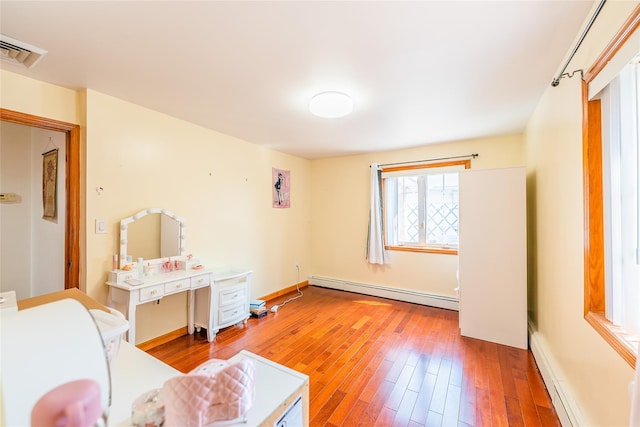 145-04 21st Ave, Whitestone, NY 11357 - living area with a baseboard radiator, hardwood / wood-style floors, and a baseboard heating unit