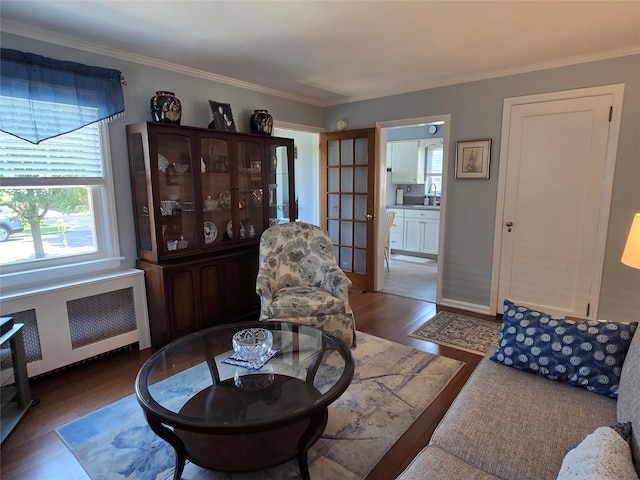 29 Irving St, Valley Stream, NY 11580 - living area with radiator heating unit, wood finished floors, and ornamental molding