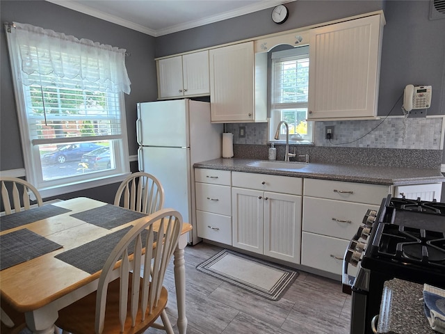 29 Irving St, Valley Stream, NY 11580 - kitchen featuring freestanding refrigerator, gas stove, tasteful backsplash, dark countertops, and white cabinetry