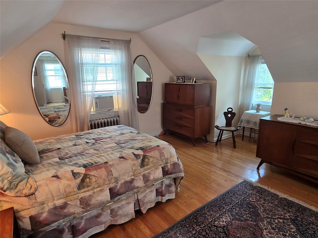 29 Irving St, Valley Stream, NY 11580 - bedroom with radiator heating unit, lofted ceiling, light wood-style floors, and cooling unit