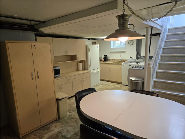 29 Irving St, Valley Stream, NY 11580 - kitchen with freestanding refrigerator, stainless steel microwave, light countertops, and decorative light fixtures