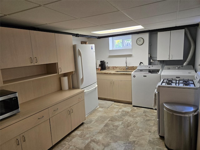 29 Irving St, Valley Stream, NY 11580 - kitchen with white appliances, a paneled ceiling, light countertops, washer and dryer, and light brown cabinets