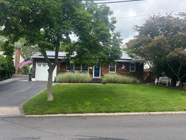 16 Capitol Pl S, Huntington, NY 11746 - view of front of property featuring solar panels, driveway, an attached garage, and covered porch
