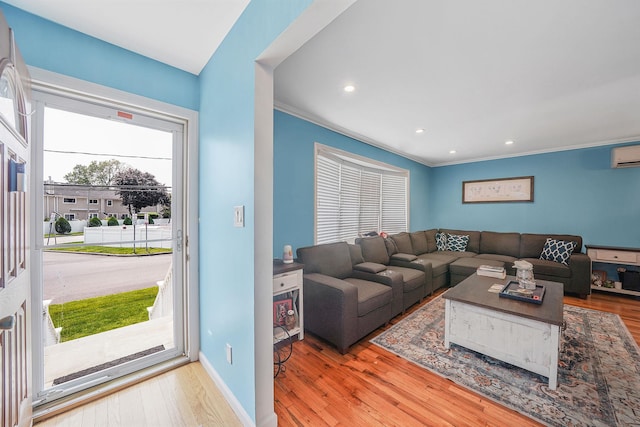 123 Baker Ct, Island Park, NY 11558 - living area with wood finished floors, crown molding, recessed lighting, baseboards, and a wall mounted air conditioner