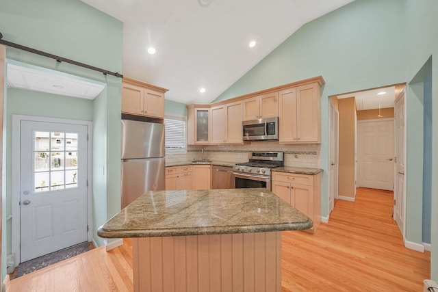 123 Baker Ct, Island Park, NY 11558 - kitchen with appliances with stainless steel finishes, light brown cabinetry, decorative backsplash, a sink, and light wood finished floors