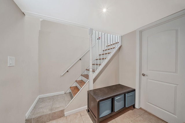 123 Baker Ct, Island Park, NY 11558 - stairway featuring baseboards and tile patterned floors