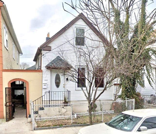 4439 Mundy Ln, Bronx, NY 10466 - view of front of house with a fenced front yard and a chimney