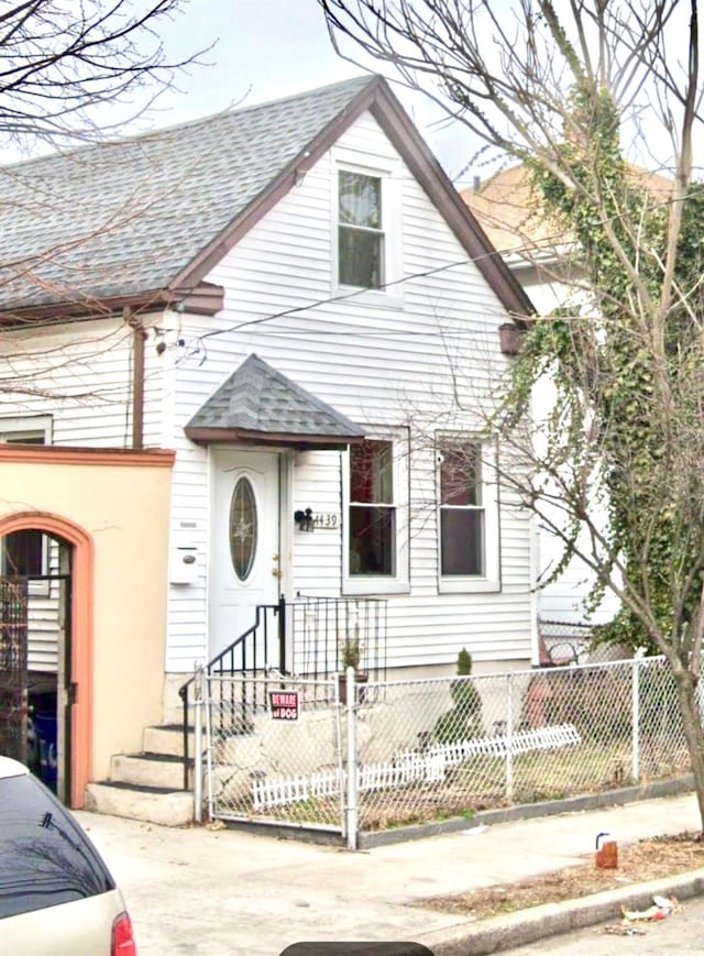 4439 Mundy Ln, Bronx, NY 10466 - view of front of home featuring a shingled roof and a fenced front yard