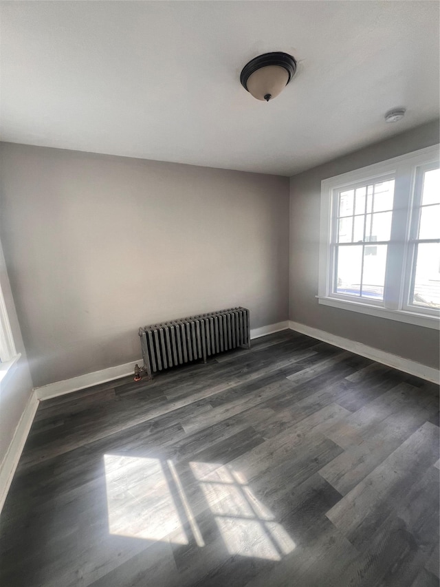 27 Hooker Ave, Poughkeepsie, NY 12601 - empty room featuring radiator heating unit, wood finished floors, and a smoke detector