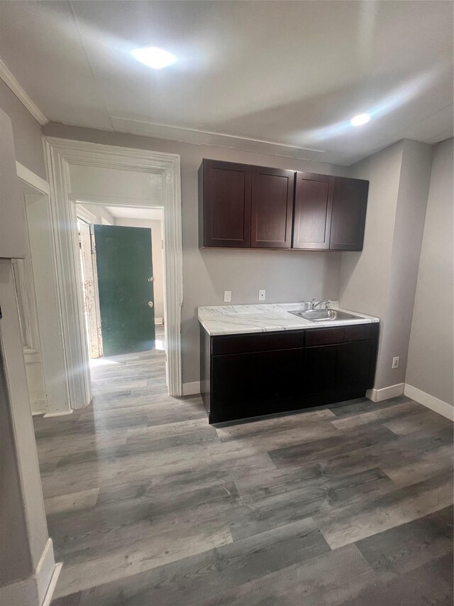 27 Hooker Ave, Poughkeepsie, NY 12601 - kitchen with wood finished floors, dark brown cabinets, light countertops, and ornamental molding