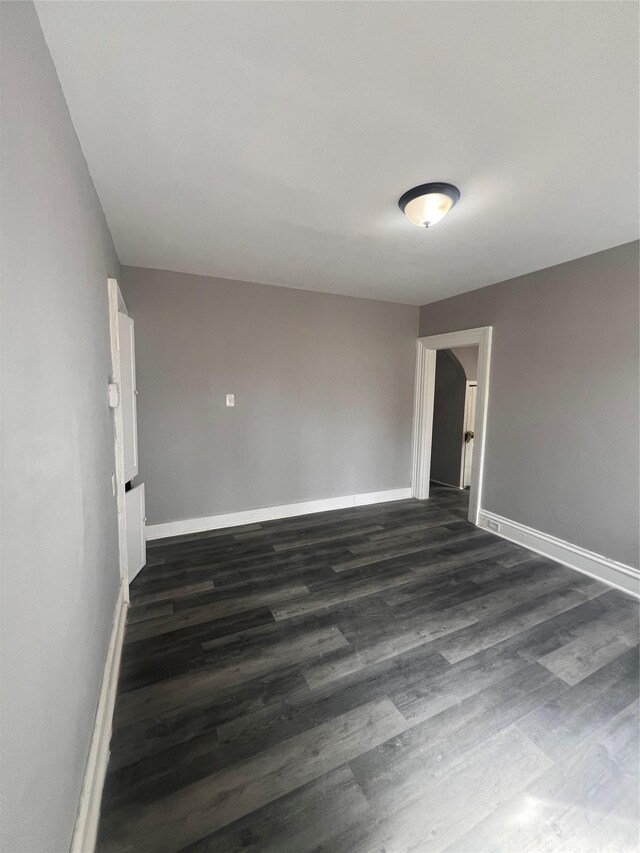 27 Hooker Ave, Poughkeepsie, NY 12601 - empty room with dark wood-style floors and baseboards
