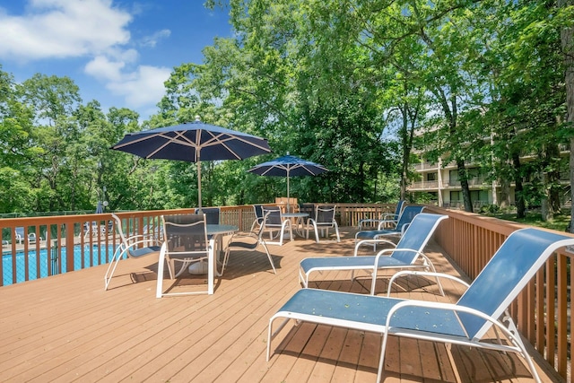 150 Overlook Ave Unit 5K, Peekskill, NY 10566 - wooden deck with outdoor dining area, an outdoor pool, and view of scattered trees