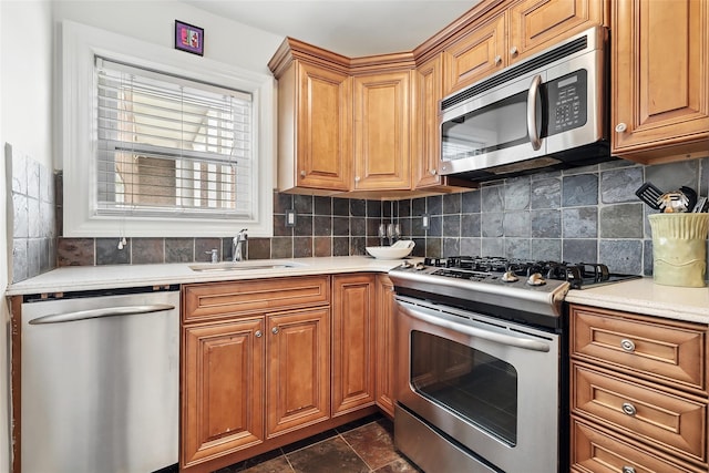 1833 Palmer Ave Unit 2C, Larchmont, NY 10538 - kitchen with appliances with stainless steel finishes, a sink, light countertops, backsplash, and brown cabinets