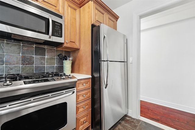 1833 Palmer Ave Unit 2C, Larchmont, NY 10538 - kitchen featuring appliances with stainless steel finishes, tasteful backsplash, light countertops, baseboards, and brown cabinets