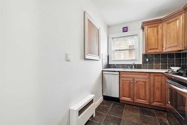 1833 Palmer Ave Unit 2C, Larchmont, NY 10538 - kitchen featuring stainless steel appliances, a sink, backsplash, and brown cabinetry