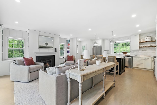 200 Millwood Rd, Chappaqua, NY 10514 - living area with a glass covered fireplace, recessed lighting, and light wood-type flooring