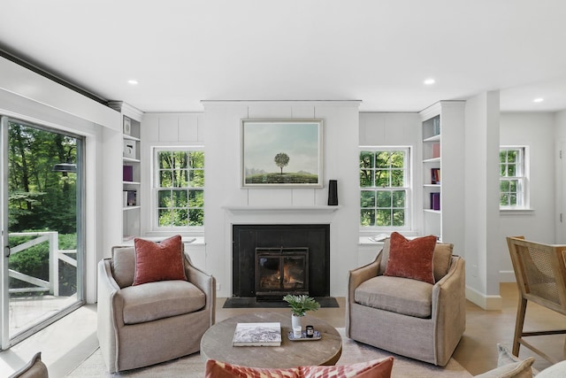 200 Millwood Rd, Chappaqua, NY 10514 - living area with built in shelves, a fireplace with flush hearth, recessed lighting, baseboards, and wood finished floors