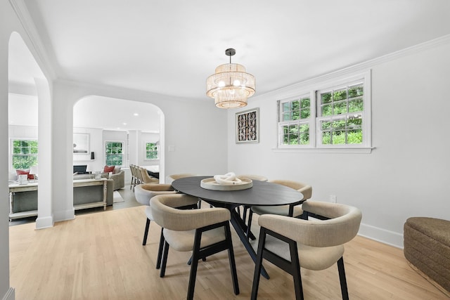 200 Millwood Rd, Chappaqua, NY 10514 - dining room with arched walkways, ornamental molding, plenty of natural light, a chandelier, and light wood-style floors