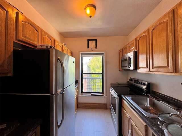 30 Clinton Pl Unit 6E, New Rochelle, NY 10801 - kitchen featuring stainless steel appliances, dark countertops, and brown cabinetry