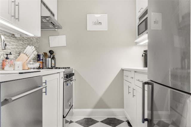210 E 63rd St Unit 10E, New York Manhattan, NY 10065 - kitchen featuring appliances with stainless steel finishes, backsplash, exhaust hood, white cabinetry, and light countertops