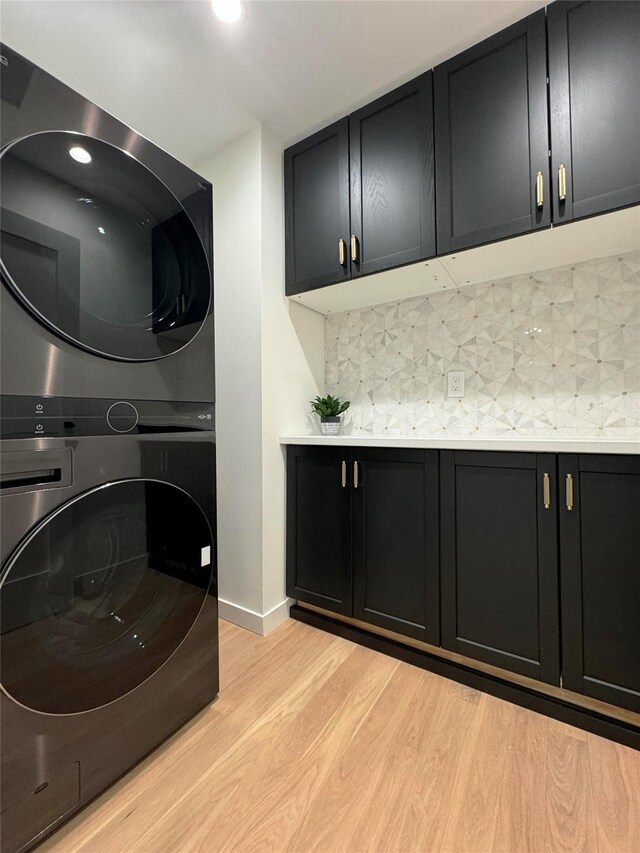 10 Lenape Rd, Southampton, NY 11968 - laundry room with cabinet space, estacked washer and dryer, light wood-type flooring, baseboards, and recessed lighting