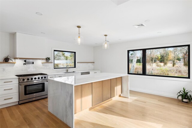 10 Lenape Rd, Southampton, NY 11968 - kitchen featuring appliances with stainless steel finishes, a sink, decorative backsplash, and healthy amount of natural light