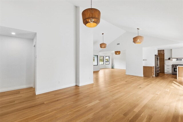 10 Lenape Rd, Southampton, NY 11968 - unfurnished living room featuring high vaulted ceiling, light wood-type flooring, and baseboards