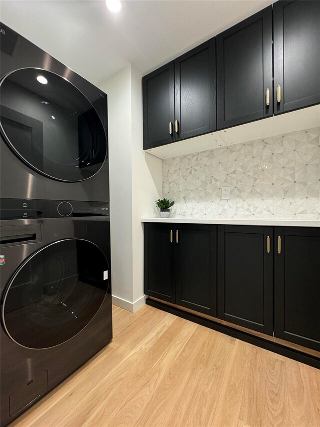 10 Lenape Rd, Southampton, NY 11968 - washroom with stacked washer / drying machine, cabinet space, light wood finished floors, recessed lighting, and baseboards