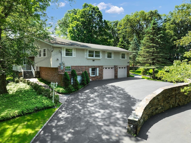 125 Park Ln, West Harrison, NY 10604 - view of front of house featuring driveway, an attached garage, and stairway
