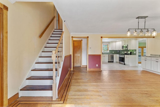 4 W Burda Pl, New City, NY 10956 - stairs featuring wood finished floors, ornamental molding, and baseboards
