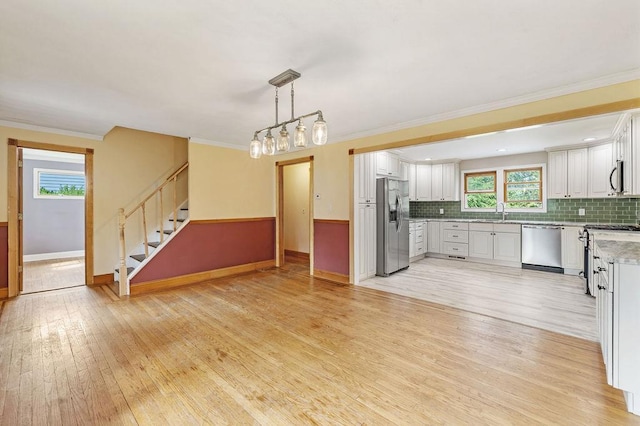4 W Burda Pl, New City, NY 10956 - kitchen with stainless steel appliances, baseboards, a sink, light wood-style floors, and ornamental molding
