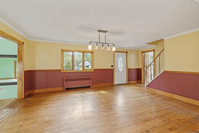 4 W Burda Pl, New City, NY 10956 - spare room with radiator heating unit, light wood-style floors, stairs, baseboards, and crown molding