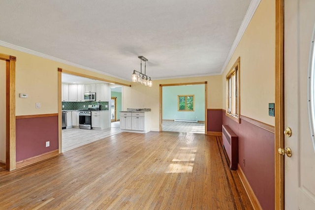 4 W Burda Pl, New City, NY 10956 - unfurnished living room featuring a baseboard radiator, light wood-style flooring, ornamental molding, and baseboards
