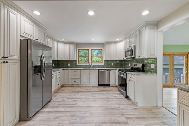 4 W Burda Pl, New City, NY 10956 - kitchen with appliances with stainless steel finishes, a sink, tasteful backsplash, light wood finished floors, and recessed lighting